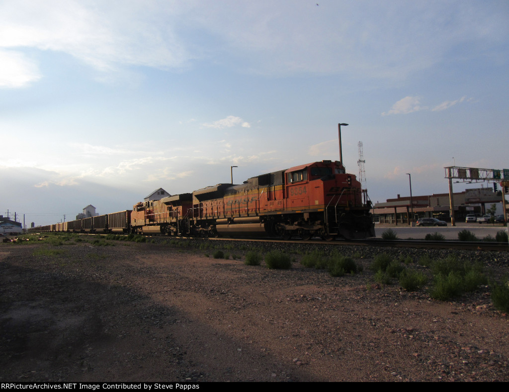 BNSF 9354 taking a train through town